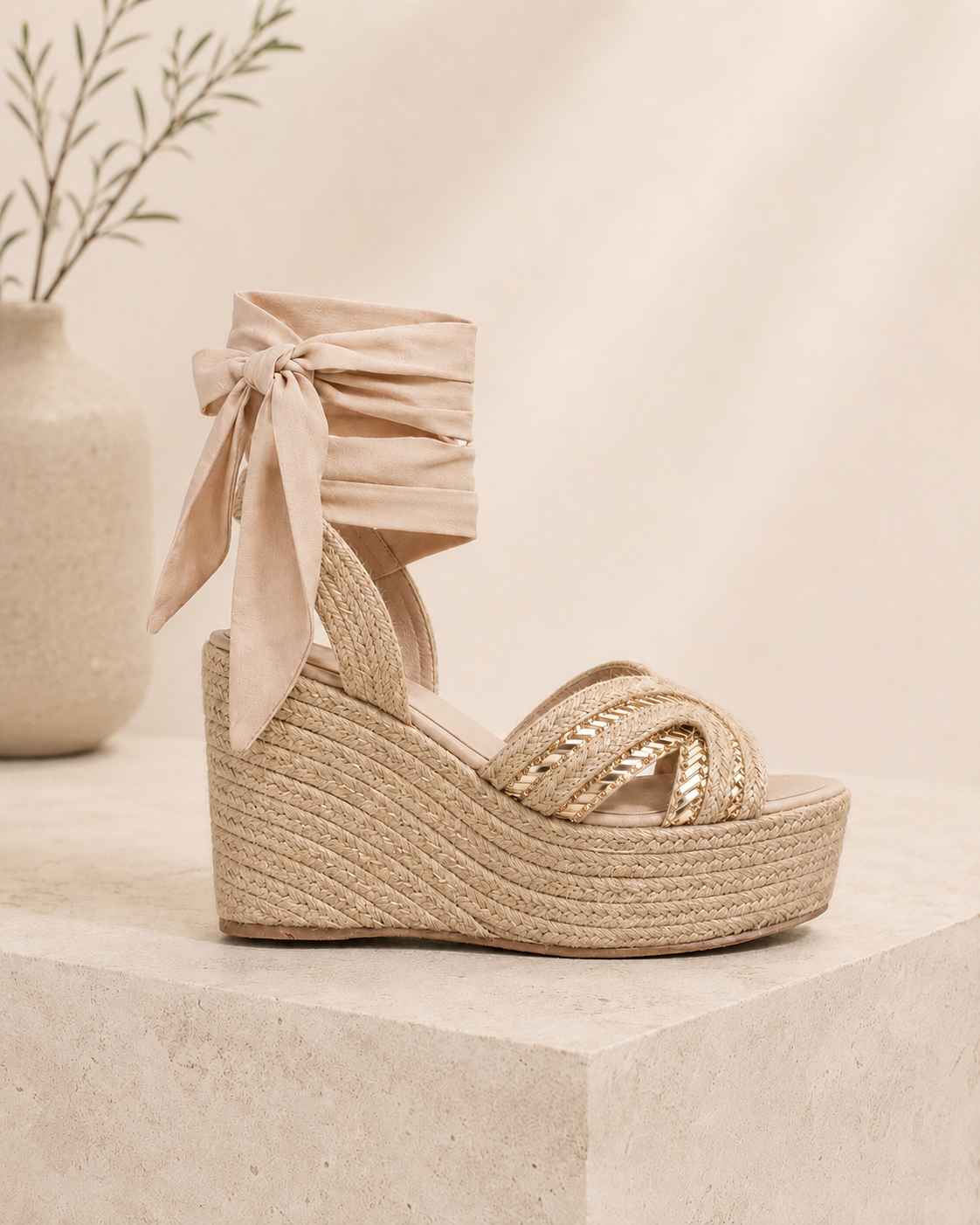 Woman wearing natural jute espadrille wedge sandals with wrap-around fabric ties and metallic champagne accents by MonikCreations.
