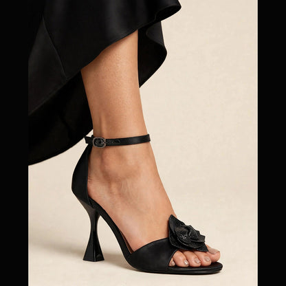 Fleur Crystal Sandal in black - satin sandal with crystal flower applique and sculptural heel, worn on foot