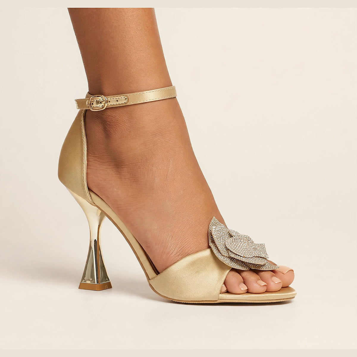 Fleur Crystal Sandal in gold - satin sandal with crystal flower applique and sculptural heel, worn on foot
