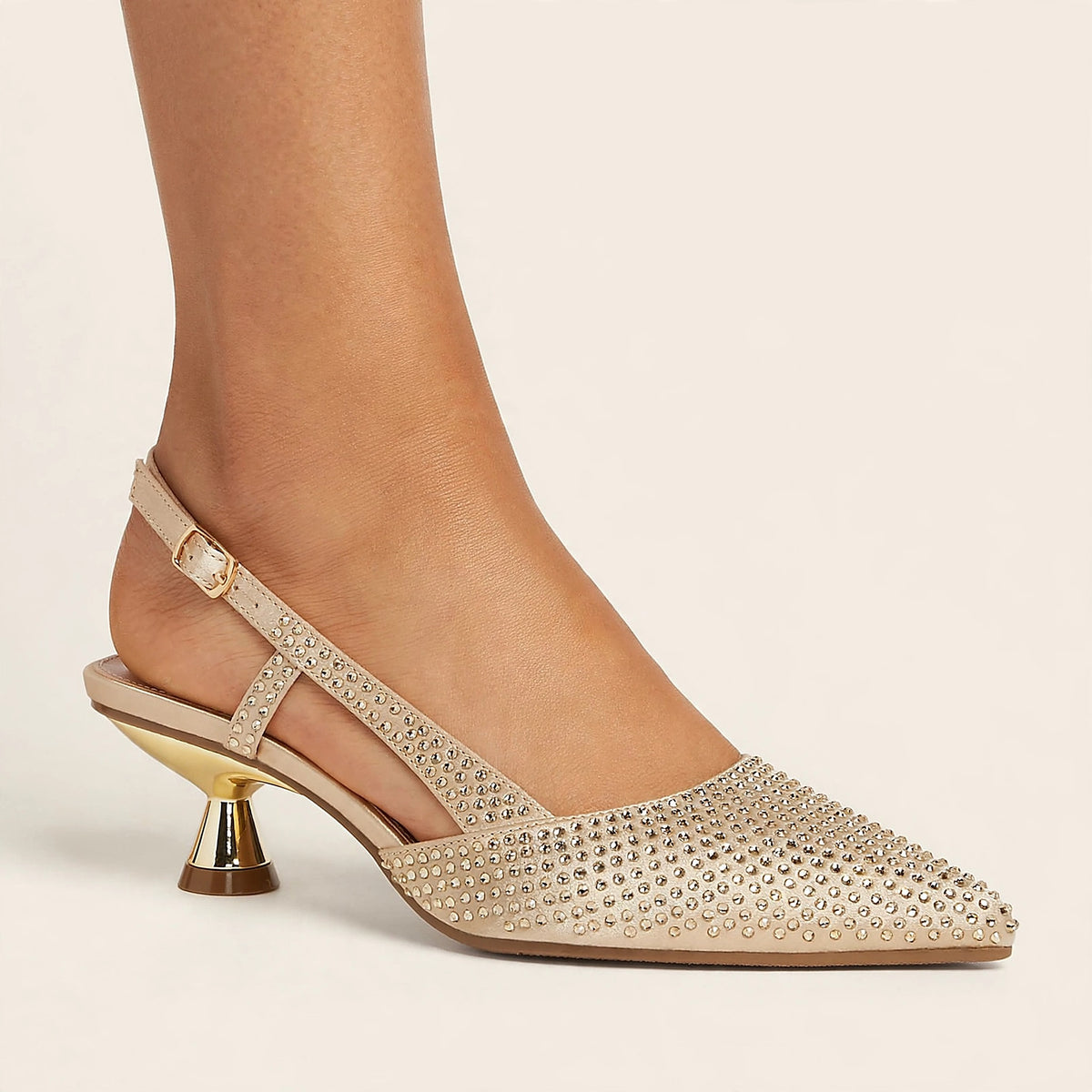 Noir Crystal Slingback in gold - rhinestone pointed-toe slingback pump with spool heel, worn on foot